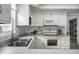 Bright kitchen features white cabinets, modern appliances, and a stainless steel sink beneath a window at 10833 Marquette Rd, Zionsville, IN 46077