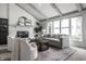 Cozy living room boasts a brick fireplace, beamed ceiling, large windows, and stylish furnishings at 10833 Marquette Rd, Zionsville, IN 46077