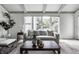 Bright living room features a large window, hardwood floors, a comfortable couch and accent chair at 10833 Marquette Rd, Zionsville, IN 46077