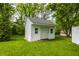 Charming outdoor shed with white siding and a functional roll-up door, ideal for storage at 10833 Marquette Rd, Zionsville, IN 46077