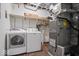 Basement Laundry room area equipped with a washer, dryer, and shelving for storage at 11123 Haverstick Rd, Carmel, IN 46033