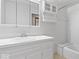 Classic white bathroom featuring a tub, shower, and a vanity with storage at 11123 Haverstick Rd, Carmel, IN 46033