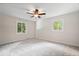 Bedroom featuring neutral tones, carpet, and two windows at 11123 Haverstick Rd, Carmel, IN 46033