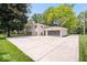 Exterior view of a bright home with a large driveway and a spacious two-car garage at 11123 Haverstick Rd, Carmel, IN 46033
