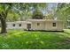 Charming single-story home featuring a lush green lawn and beautiful mature trees at 11123 Haverstick Rd, Carmel, IN 46033