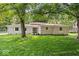 Charming single-story home featuring a lush green lawn and beautiful mature trees at 11123 Haverstick Rd, Carmel, IN 46033