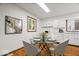 Eat-in kitchen with updated white cabinets, appliances, and hardwood floors at 11123 Haverstick Rd, Carmel, IN 46033