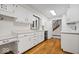 Bright kitchen featuring white cabinetry, wood floors, and stainless steel appliances at 11123 Haverstick Rd, Carmel, IN 46033