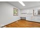 Kitchen with white cabinets, hardwood floors, and window at 11123 Haverstick Rd, Carmel, IN 46033