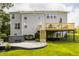 Spacious backyard with a deck, hot tub, stamped concrete patio, and a well-maintained lawn at 11552 Buckskin Dr, Zionsville, IN 46077