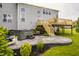 Backyard featuring a patio with a hot tub, a deck, green lawn, and landscaping at 11552 Buckskin Dr, Zionsville, IN 46077