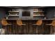 The basement bar has stylish seating and open shelving, offering both functionality and aesthetic appeal at 11552 Buckskin Dr, Zionsville, IN 46077