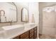 Bright bathroom with double sinks, vessel sinks, wooden cabinets, mirrors, and stylish lighting at 11552 Buckskin Dr, Zionsville, IN 46077