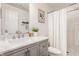 Well-lit bathroom featuring a gray vanity with marble countertop and a shower with a white curtain at 11552 Buckskin Dr, Zionsville, IN 46077