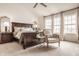 Bright bedroom with large windows, vaulted ceiling, wood furniture, and neutral carpet at 11552 Buckskin Dr, Zionsville, IN 46077
