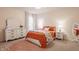 Cozy bedroom with orange bedding, white dresser, and matching nightstands, creating a warm inviting atmosphere at 11552 Buckskin Dr, Zionsville, IN 46077