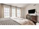Bedroom featuring a large window, chest of drawers, and floral bedding at 11552 Buckskin Dr, Zionsville, IN 46077