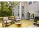 Outdoor deck featuring modern seating, side table, and a fire pit overlooking the backyard at 11552 Buckskin Dr, Zionsville, IN 46077