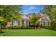 Charming brick home featuring manicured lawn, beautiful landscaping, and a welcoming facade at 11552 Buckskin Dr, Zionsville, IN 46077