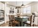 Bright kitchen with white cabinets, stone countertops, and stainless steel appliances at 11552 Buckskin Dr, Zionsville, IN 46077