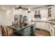 Modern kitchen with white cabinets, backsplash, and stainless steel appliances at 11552 Buckskin Dr, Zionsville, IN 46077