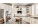 Modern kitchen with white cabinets, backsplash, and stainless steel appliances at 11552 Buckskin Dr, Zionsville, IN 46077