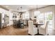 Eat-in kitchen features a central island and stainless steel appliances at 11552 Buckskin Dr, Zionsville, IN 46077