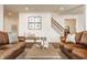 Comfortable living room featuring neutral decor, wood floors, and staircase access at 11552 Buckskin Dr, Zionsville, IN 46077