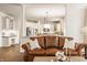 Comfortable living room showcases modern kitchen with stainless steel appliances at 11552 Buckskin Dr, Zionsville, IN 46077