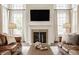 Cozy living room featuring a fireplace, neutral color scheme, and comfortable seating arrangement at 11552 Buckskin Dr, Zionsville, IN 46077