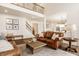 Inviting living room features hardwood floors, comfortable leather sofas, and an open floor plan at 11552 Buckskin Dr, Zionsville, IN 46077