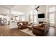 Open-concept living room with fireplace and view into kitchen with white cabinets and stainless appliances at 11552 Buckskin Dr, Zionsville, IN 46077