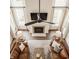 Aerial view of living room featuring fireplace, high ceilings, and comfortable leather couches at 11552 Buckskin Dr, Zionsville, IN 46077