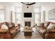 Bright and airy living room featuring high ceilings, fireplace, and comfortable leather couches at 11552 Buckskin Dr, Zionsville, IN 46077