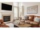 Inviting living room with fireplace, comfortable seating, and a world map on the wall at 11552 Buckskin Dr, Zionsville, IN 46077
