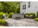Outdoor patio featuring a hot tub, chairs, and landscaped bushes with a view of the house at 11552 Buckskin Dr, Zionsville, IN 46077