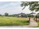 Community playground featuring slides, swings, and other play equipment surrounded by a grassy field at 11552 Buckskin Dr, Zionsville, IN 46077