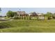 Outdoor swimming pool surrounded by lounge chairs, well-maintained landscaping, and wrought iron fencing at 11552 Buckskin Dr, Zionsville, IN 46077