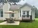 Charming backyard features a patio set with umbrella and a small deck adjacent to the house at 11700 Harvest Moon Dr, Noblesville, IN 46060