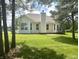 Expansive backyard featuring a large newly seeded lawn, mature trees, and deck at , Noblesville, IN 46060