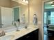Bathroom featuring double sink vanity with granite countertops, large mirror, and modern faucets at , Noblesville, IN 46060