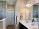 Modern bathroom with double vanity, quartz countertop, and a glass-enclosed tile shower at , Noblesville, IN 46060
