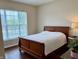 Bright bedroom featuring a large window, hardwood floors, and modern decor at , Noblesville, IN 46060