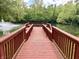 Wooden dock offers serene views of the pond, surrounded by lush greenery and trees at , Noblesville, IN 46060
