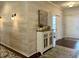 Elegant foyer with white wood-look paneling, hardwood floors, and modern lighting at , Noblesville, IN 46060