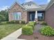 Charming front entrance with well-maintained landscaping and a blue front door at , Noblesville, IN 46060