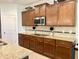 Kitchen with granite counters, tile backsplash, stainless microwave, and wooden cabinets at , Noblesville, IN 46060