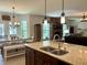 Open-concept kitchen with granite countertops, stainless steel appliances, and an adjacent dining area with modern lighting at , Noblesville, IN 46060