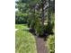 Nicely mulched landscaping featuring a lawn and evergreen trees at 11700 Harvest Moon Dr, Noblesville, IN 46060