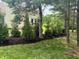 Exterior landscaping with mulch beds, evergreen trees, and view of the home at 11700 Harvest Moon Dr, Noblesville, IN 46060